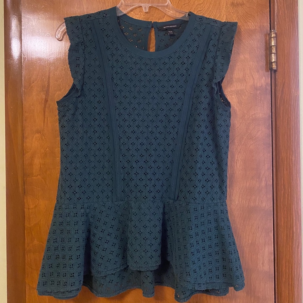 Adorable emerald green peplum top. Lined.